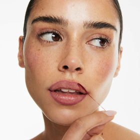 Smooche Lip Stain Watermelon Sugar application closeup showing easy peel-off formula