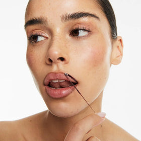 Smooche Velvet Cacao lip stain applied for precise color.