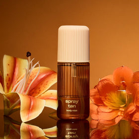 Snif Spray Tan Body Mist in tropical setting, evoking Tahitian vanilla warmth.