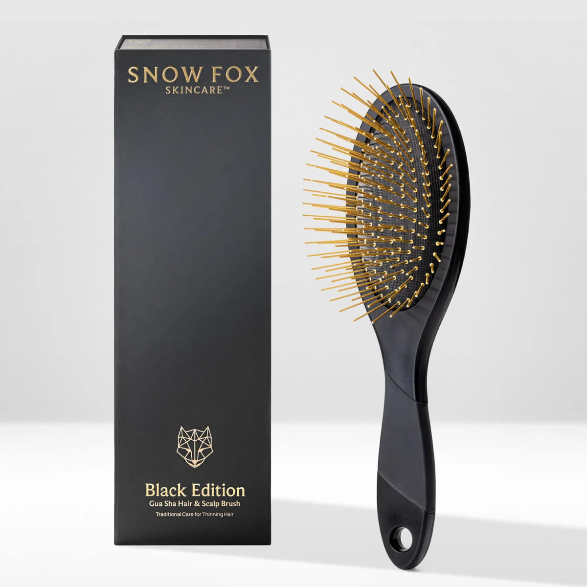 Snow Fox Skincare gua sha hair brush black edition pins close-up for scalp massage