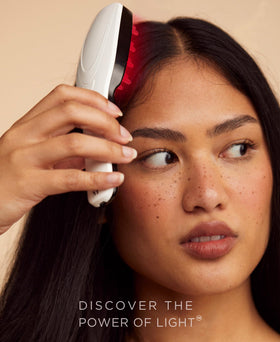 Solaris Laboratories NY Intensive Hair Stimulating Brush in hand for scalp wellness during routine.