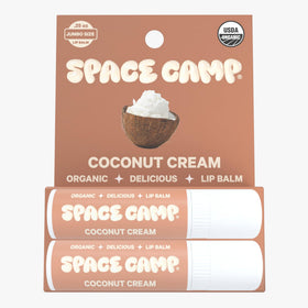 Space Camp Wellness coconut-cream texture close-up showing creamy lip hydration.