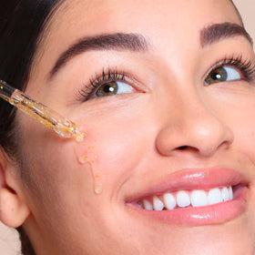 SpaLife 24k Gold Serum on cheek for hydrated glow.