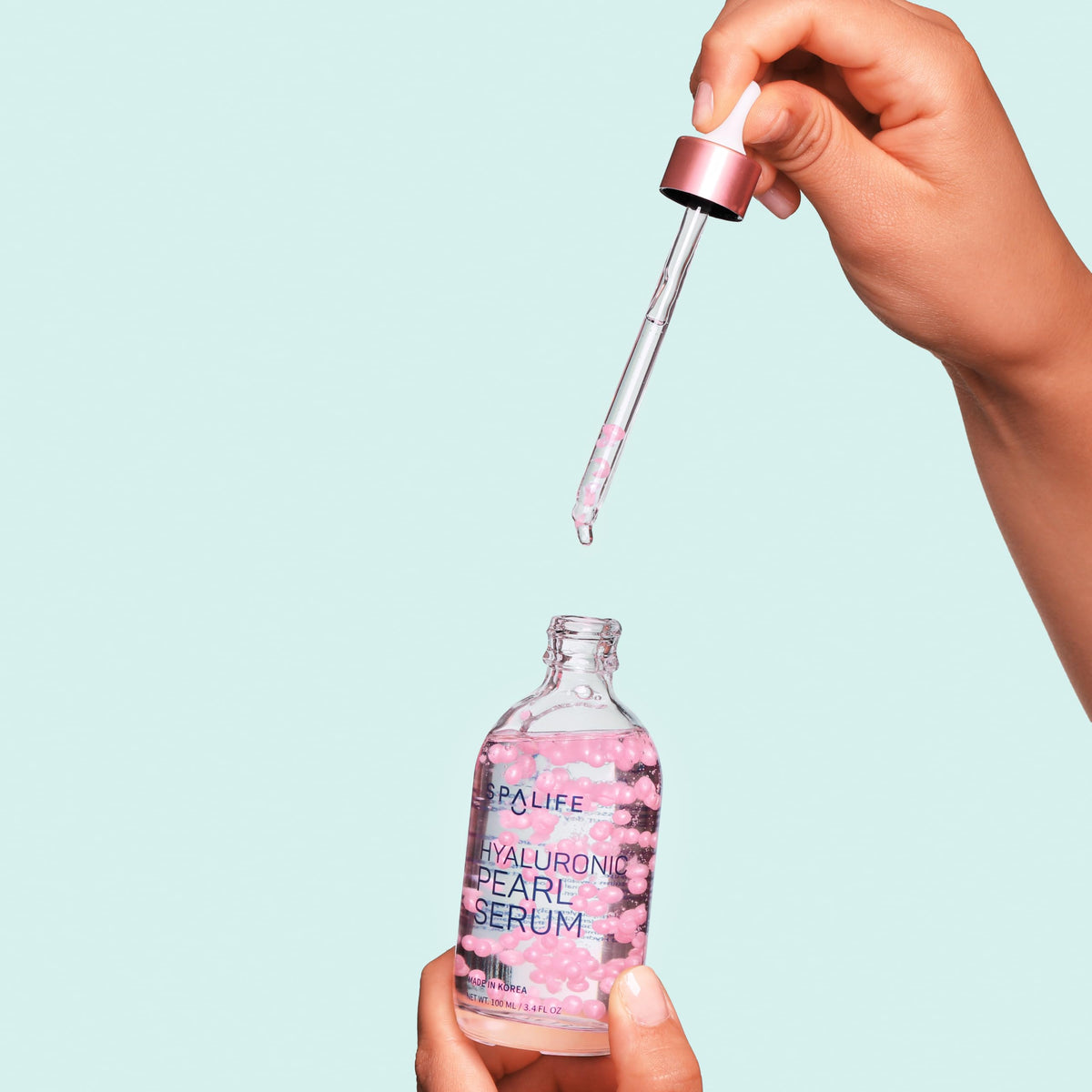 SpaLife Hyaluronic Serum bottle dispensing action for easy daily use.