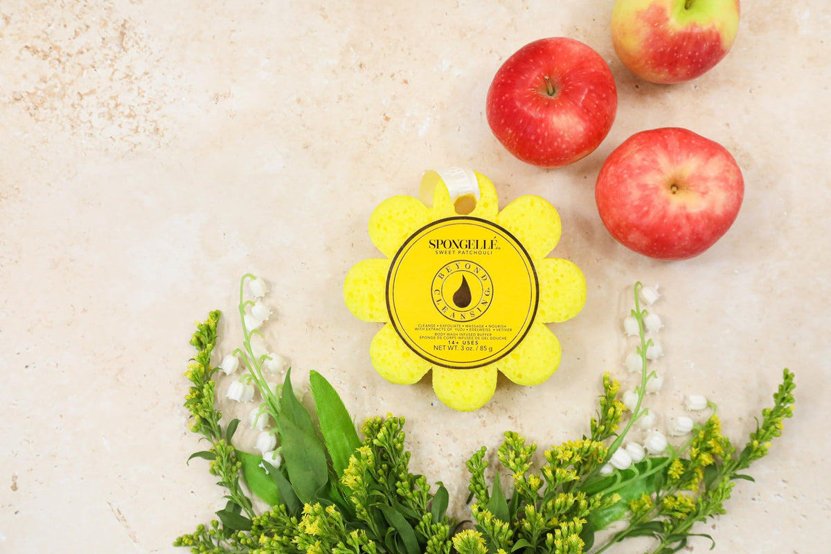 Hand holding SPONGELLÉ in shower; built-in wash activates with water for streamlined cleansing