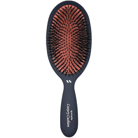 Spornette boar bristle brush close-up for smoothing and detangling.