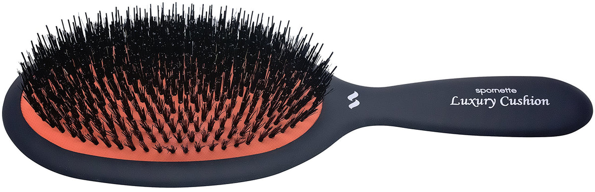 Rubber cushion reduces snagging during detangling with this brush.