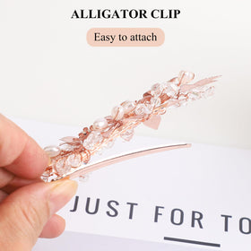 Close-up of Sppry pearls and rhinestones on clip for refined shimmer.