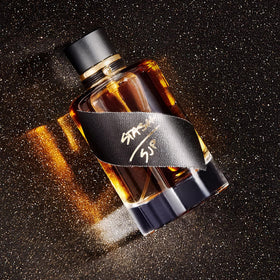 Stash by Sarah Jessica Parker bottle on vanity; elegant design complements modern photos