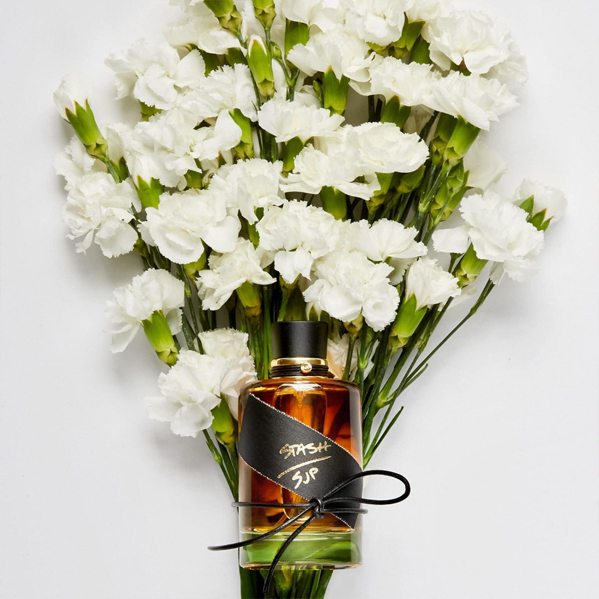 Stash by Sarah Jessica Parker bottle on packaging; gift-ready presentation with confident branding