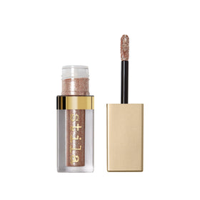 Stila Kitten Karma travel-size glitter liquid eyeshadow tube close-up showing pearl and glitter sparkle for quick day-to-night sparkle