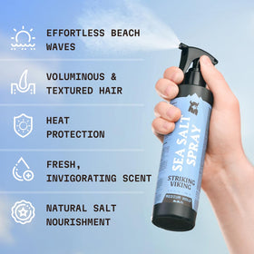 Striking Viking hands applying spray for quick, beach-ready texture.