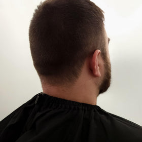 StyleCraft barber cape anti-static finish reduces hair cling on fabric.