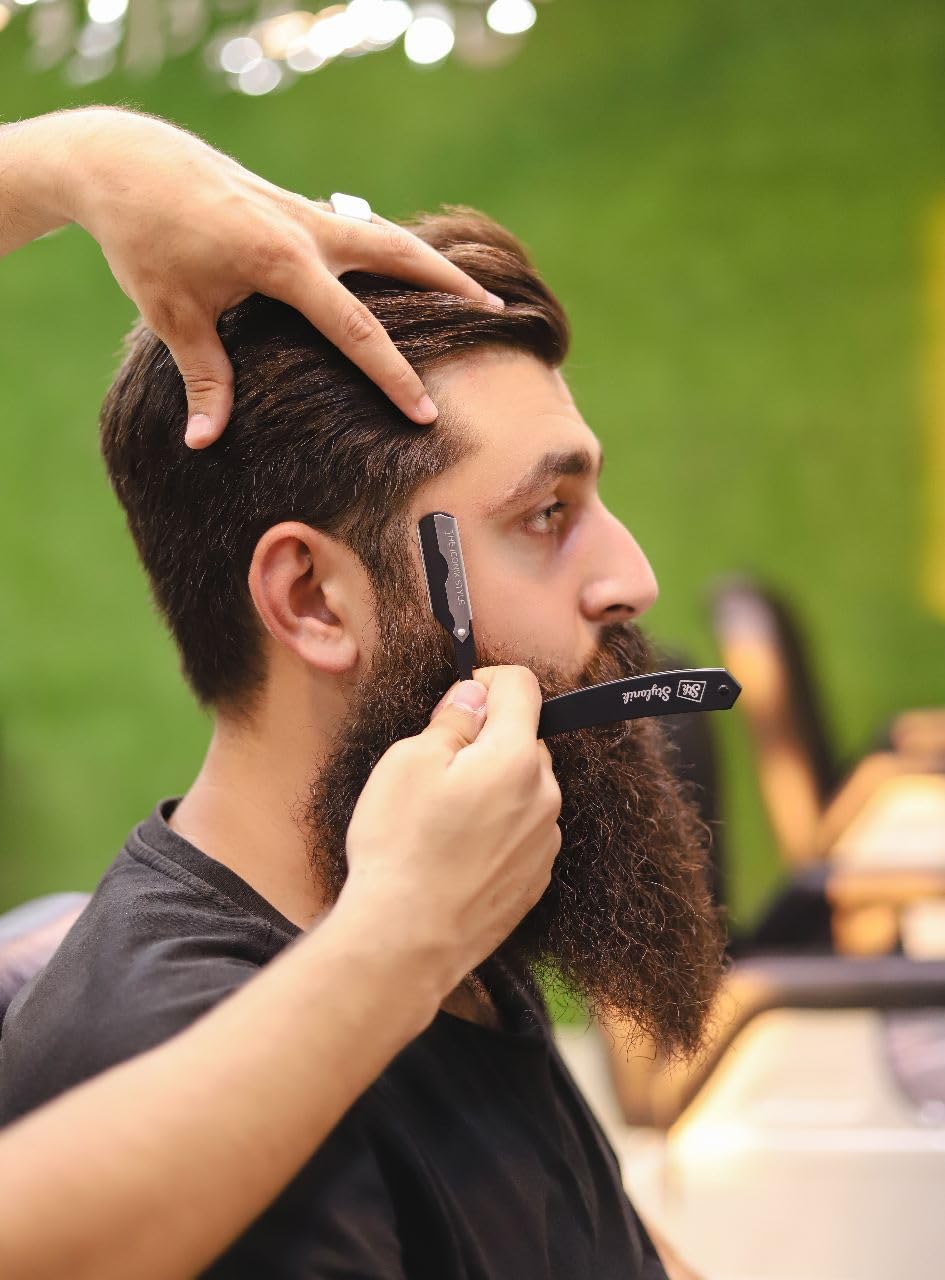 Stylonik beard trimming with straight edge razor for precise shaping.