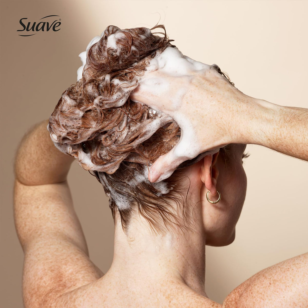 Frizz-control action on hair shown by Suave Keratin Infusion Shampoo close-up.