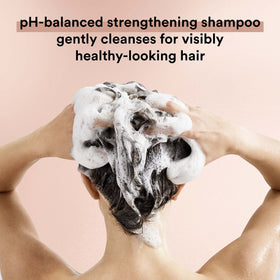 Hair strands after washing with Suave Keratin Infusion show smoothness.
