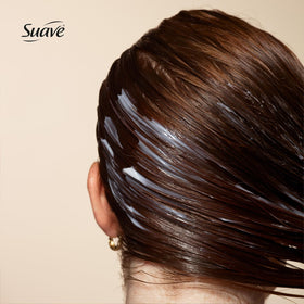 Conditioner being applied for easy detangling with Suave