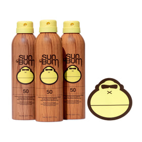 Sun Bum Original Sunscreen Spray bottle on the sand offering broad spectrum protection.