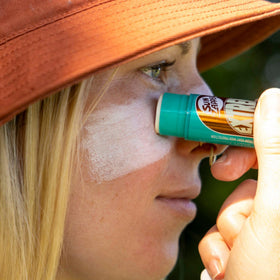 Sun Zapper Extreme Zinc Stick applying to lips and nose with precise coverage