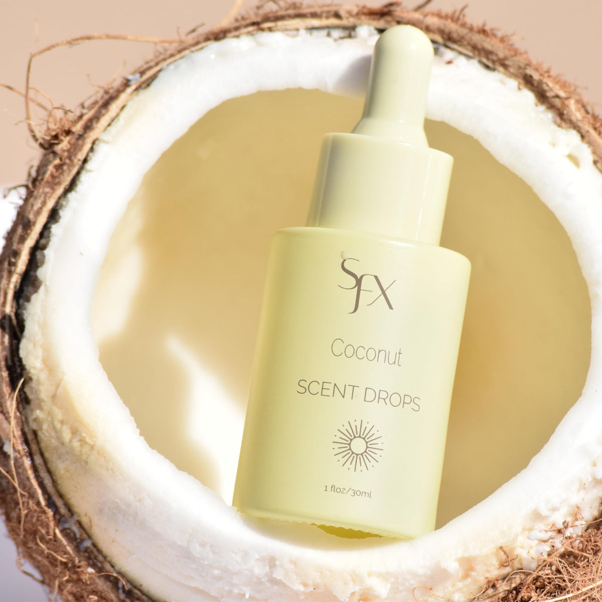 SunFX Scent Drops Coconut beside spray tan solution bottle, ready to mix.
