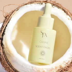 SunFX Scent Drops Coconut beside spray tan solution bottle, ready to mix.