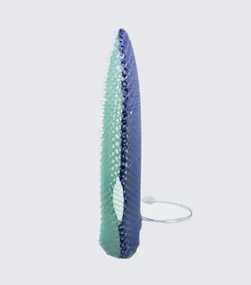 Supracor Stimulite bath mitt in use for cleansing and exfoliating across body surfaces.