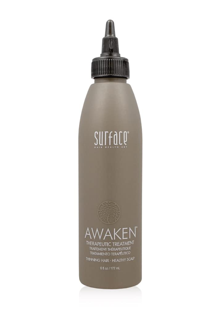 Surface Awaken bottle pour showing daily scalp care formula for healthier-looking hair