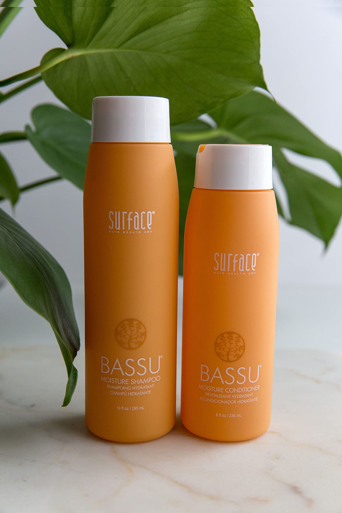 Hand applying SURFACE Bassu Moisture Shampoo for gentle cleansing and conditioning.