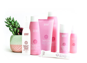 Surface Trinity Repair Tonic mist being applied to towel-dried hair for strengthening.