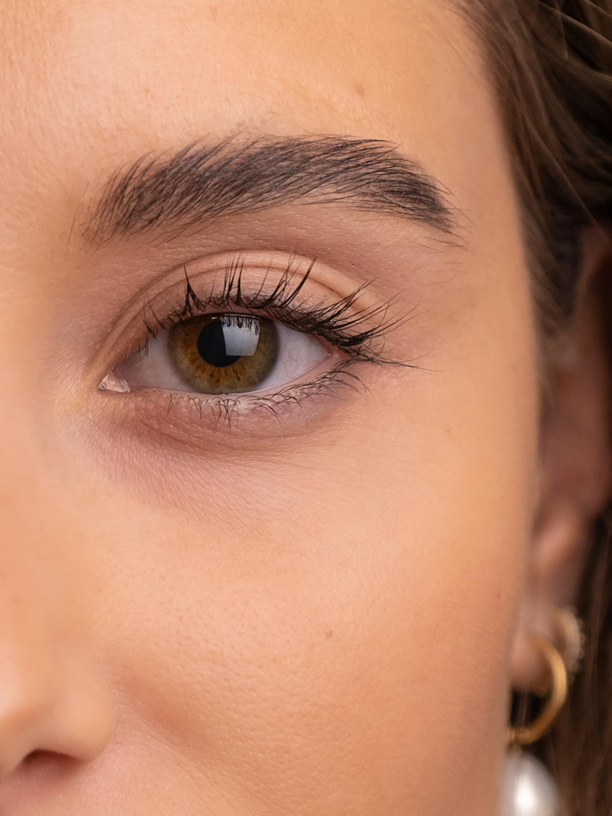 Drop of SWEED Brow Serum dispensed, showing controlled delivery.