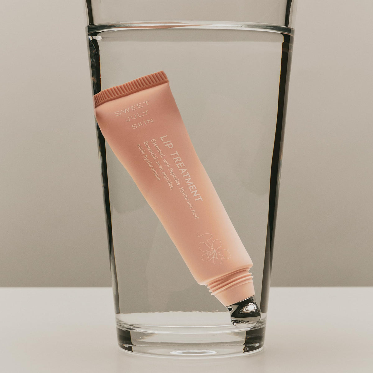 Texture closeup of SWEET JULY SKIN Lip Treatment showing smooth finish.