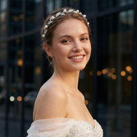 Bridal look with Sweetv headpiece enhances a polished hairstyle.
