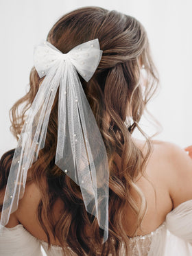 SWEETV pearl-embellished bow clip closeup showcasing secure fixation for wedding day.
