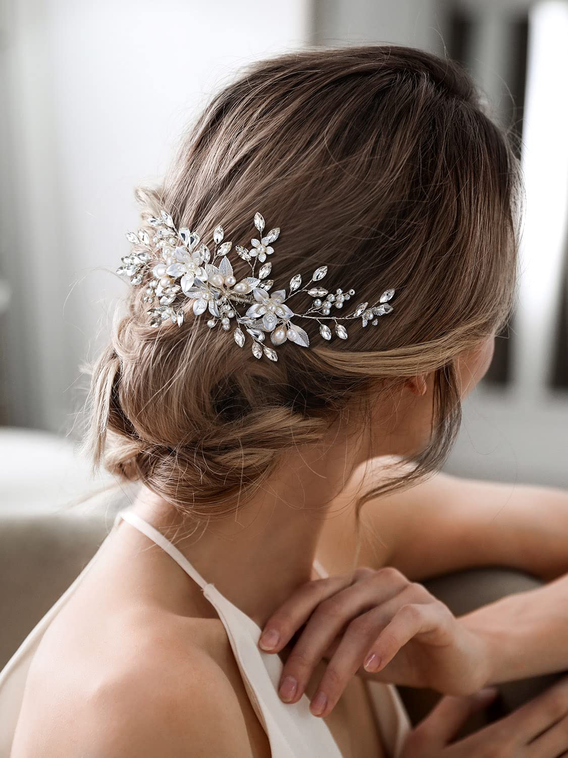 SWEETV silver-plated leaves hairpiece provides delicate detail for an upscale gown