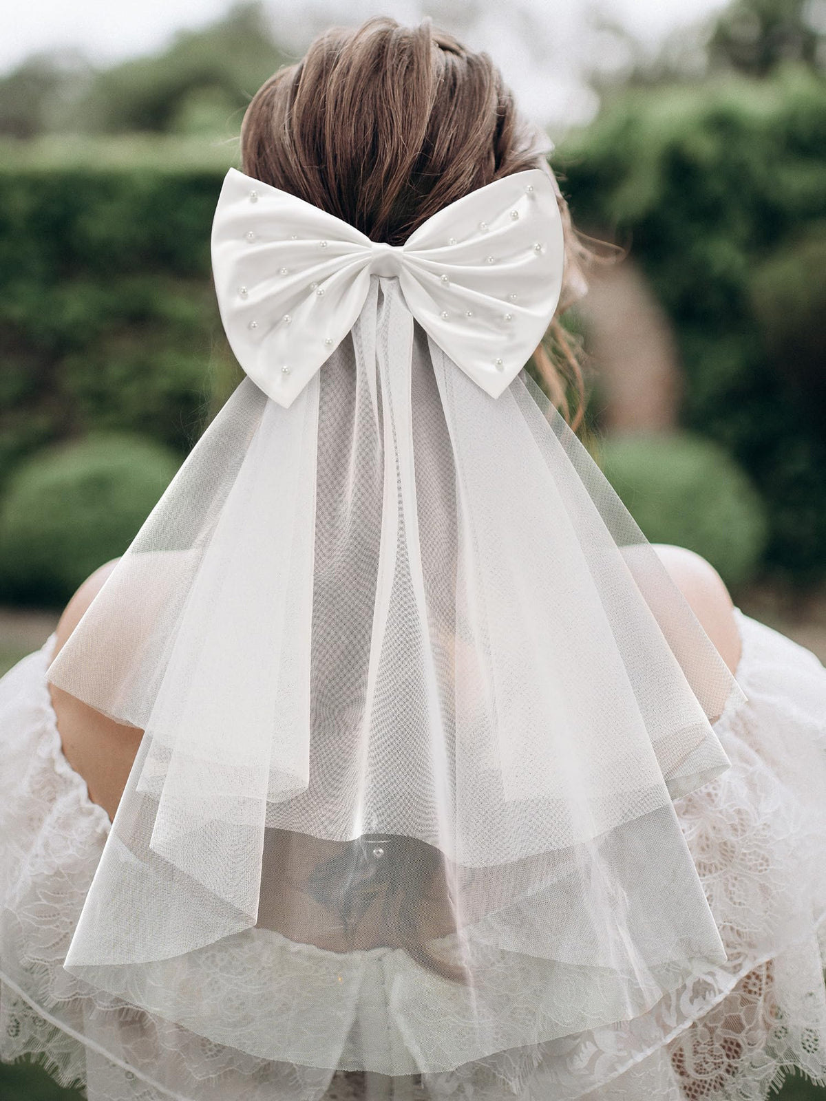 SweetV white satin bow close-up showing fixed pearls for lasting sparkle.