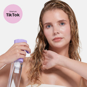 Tangle Teezer bottle on bathroom counter suggesting eco-friendly, reusable design.