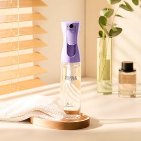 Tangle Teezer Fine Mist Bottle applying mist to strands during styling.