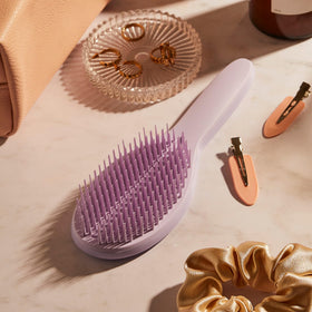 Tangle Teezer Ultimate Styler Lilac Cloud color shown with ergonomic handle.