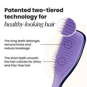 Tangle Teezer Zodiac Ultimate Detangler two-tier teeth close-up smoothing strands.