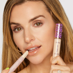 tarte lip balm on lips with mirror-shine finish.