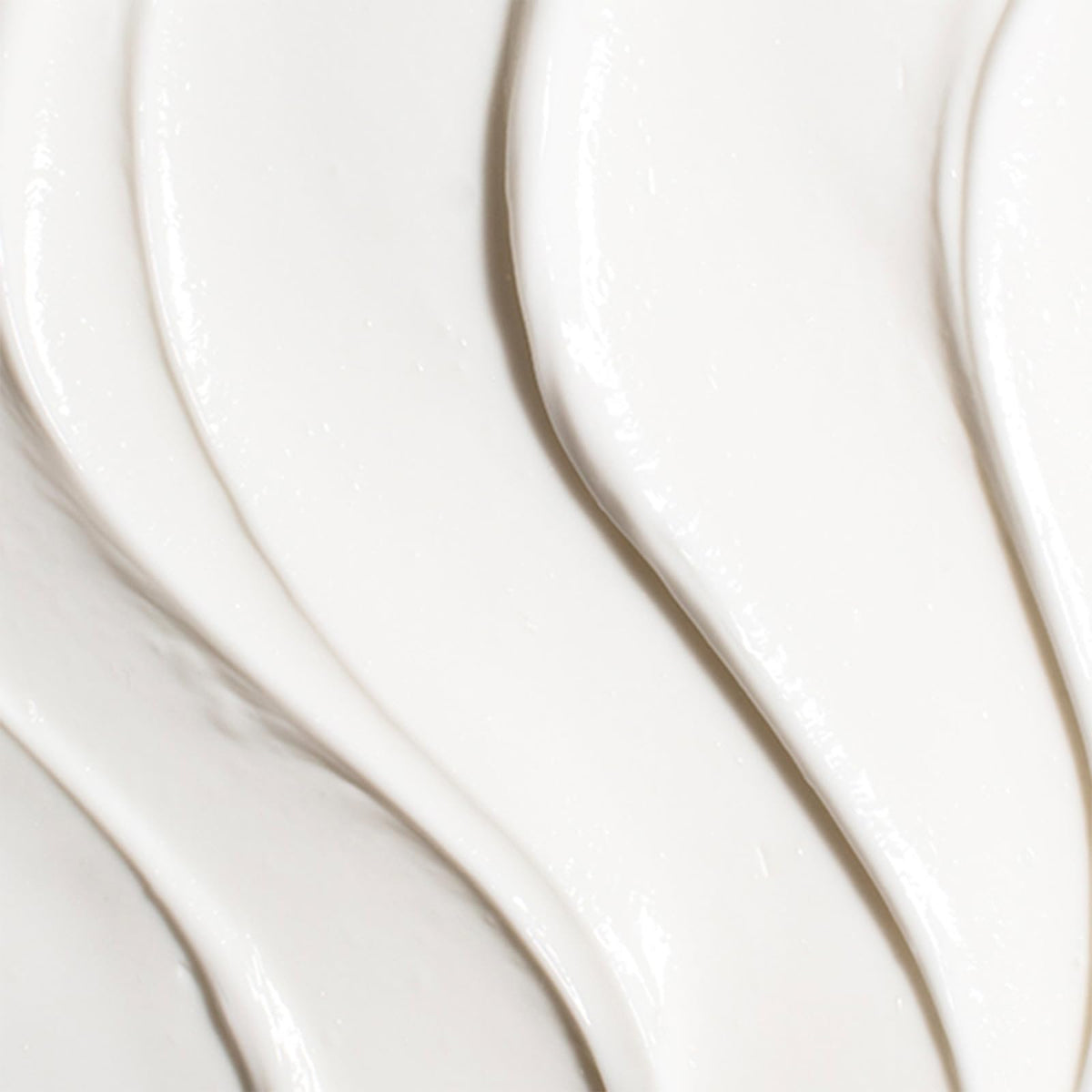 TATCHA Revitalizing Neck Cream packaging close-up with product benefits.