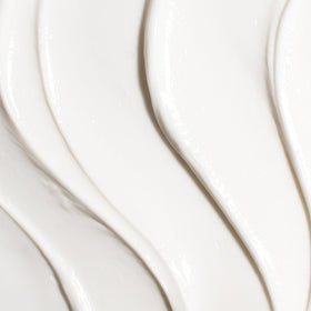 TATCHA Revitalizing Neck Cream packaging close-up with product benefits.