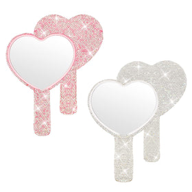 Tatuo heart mirror in pink with handle for on-the-go makeup touch-ups.