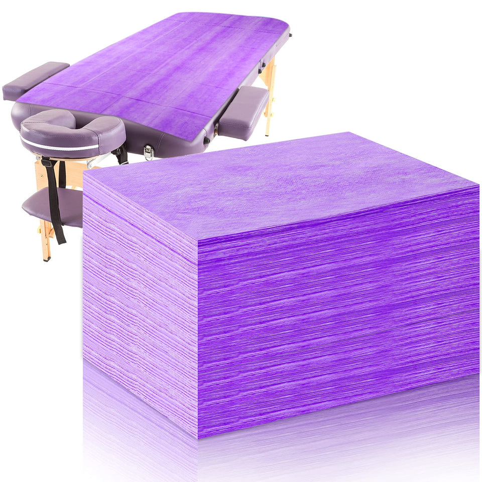 Tatuo purple disposable bed sheet on a spa table, providing clean coverage for clients