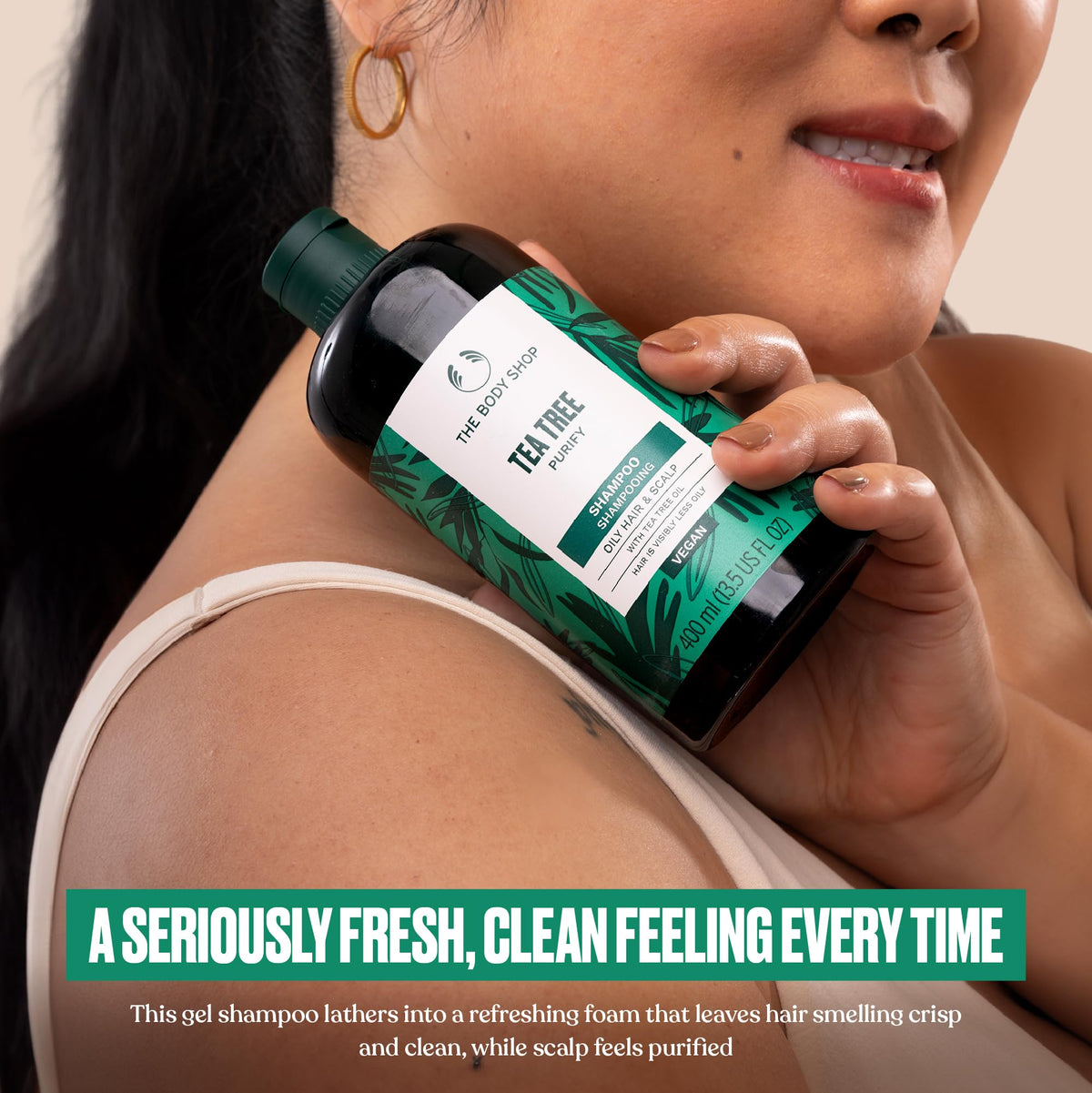 Pouring Tea Tree shampoo reveals cleansing lather for invigorating wash.