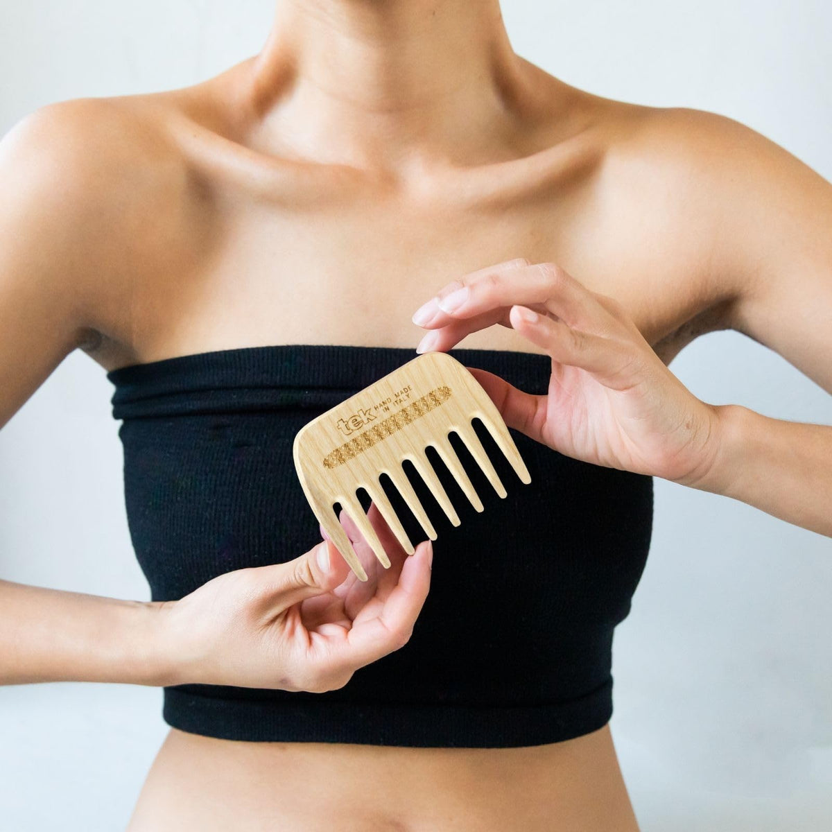 TEK handmade in Italy wooden comb showcasing craftsmanship and premium finish.