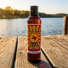 Texas Babe Tanning Oil Original bottle close-up shows a light, non-greasy texture for quick absorption.