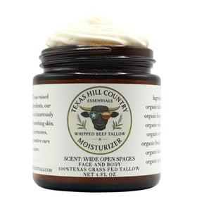 Texas Hill Country Essentials Beef Tallow Moisturizer jar on wood, whipped for deep hydration.