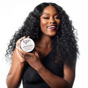 tgin Miracle RepairX model with curly hair showcasing healthy-looking strands.