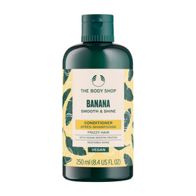 The Body Shop Banana Conditioner bottle close-up highlighting nourishing formula for dry, frizz-prone hair